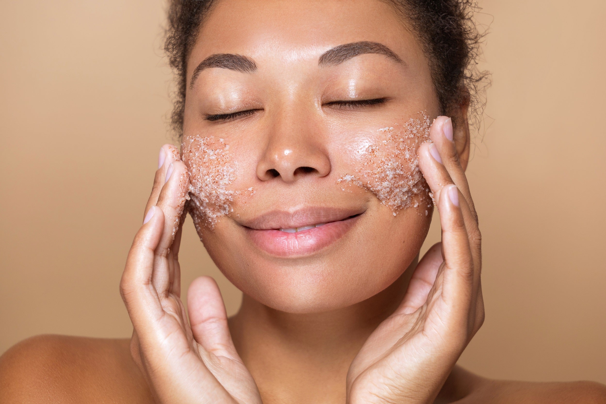 Woman exfoliating her face