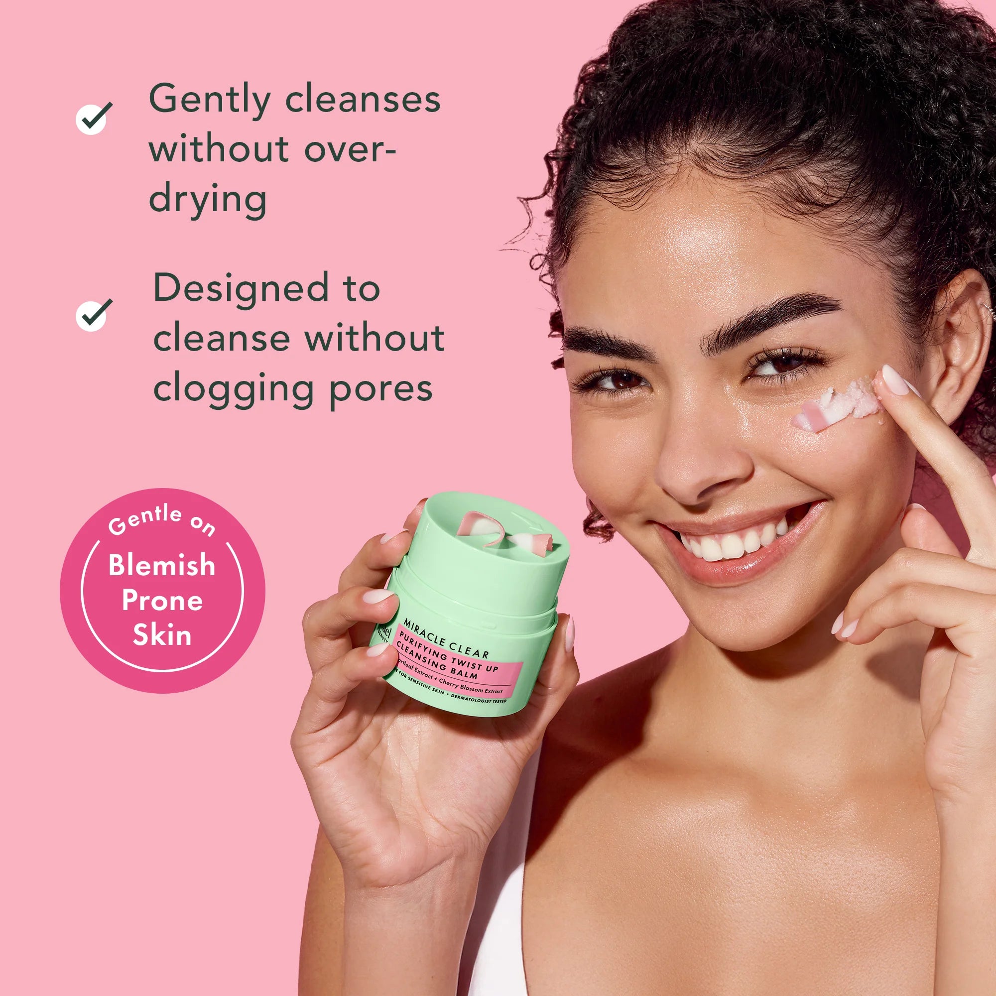 Woman holding a skincare product with text on a pink background