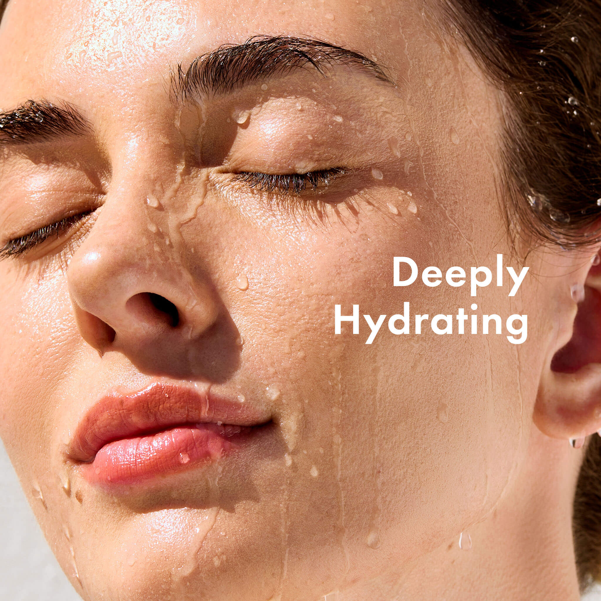 Close-up of a person's face with droplets on skin, labeled 'Deeply Hydrating'.
