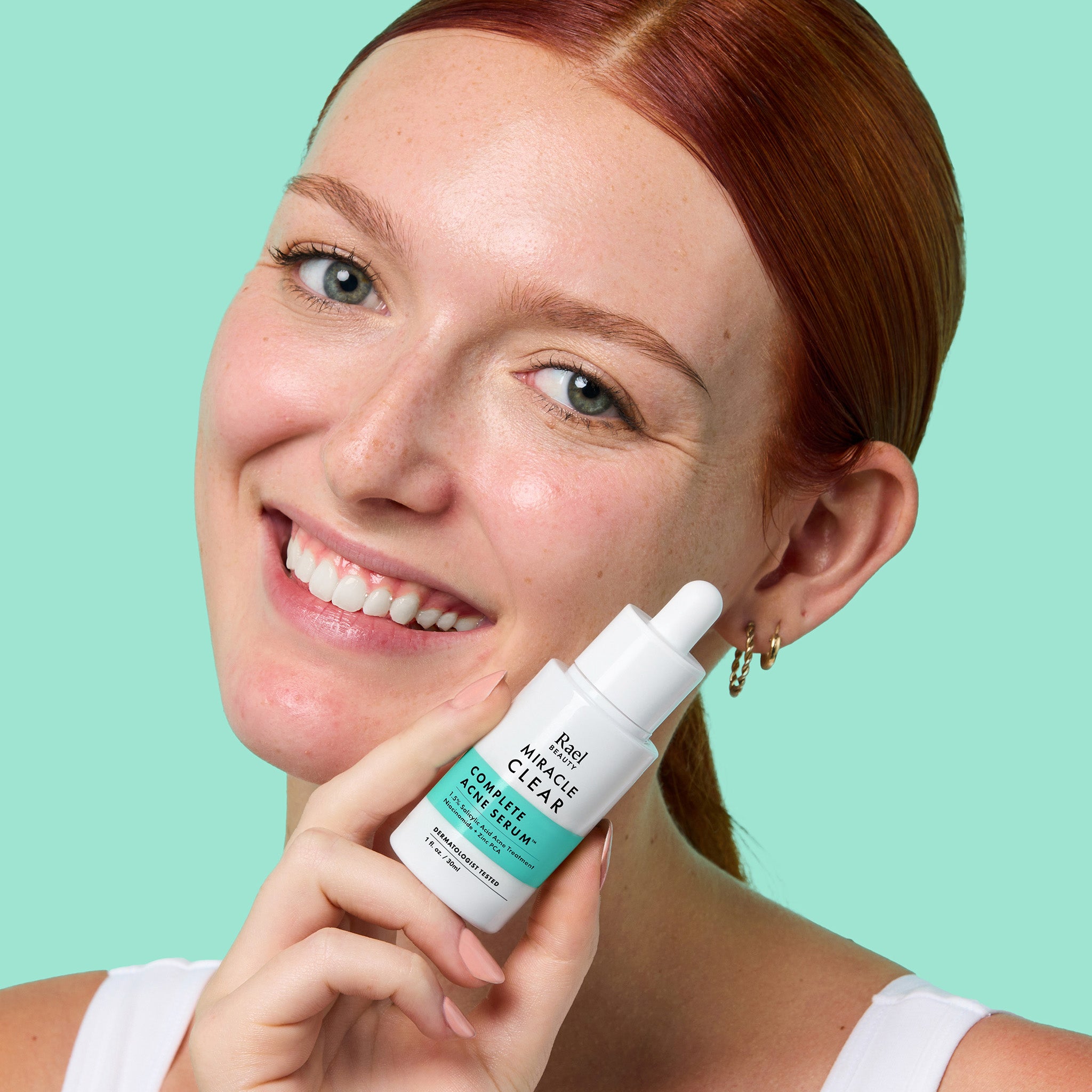 Girl holding a bottle of Miracle Clear Salicylic Acid Serum for Acne