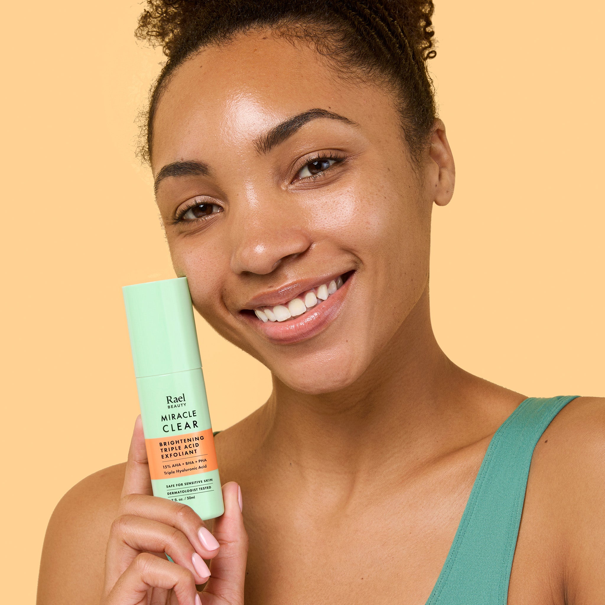 Girl holding a bottle of Brightening Liquid Exfoliator with Triple Acid Complex