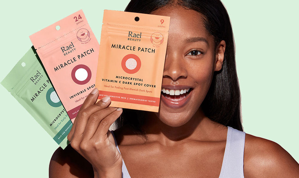 A woman holding three colorful skincare patch packets against a pale mint green background. The packets are peach, pink, and sage green, labeled 'Blast Miracle Patch' and 'Blast Miracle Patch Deep Pore Cleansing Gel.